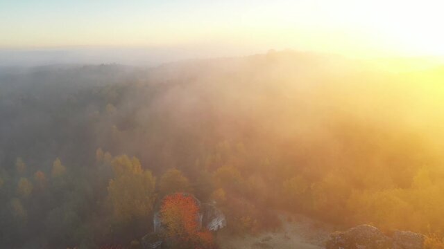 Okiennik wielki rock during autumn foggy sunrise - Jura Krakowsko-Czestochowska - Poland	