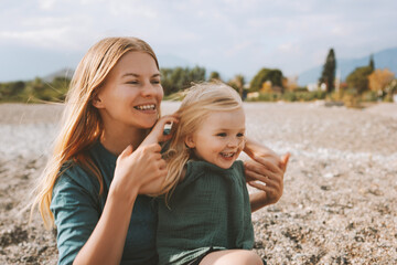 Mother and daughter playing outdoor family lifestyle happy smiling emotions blonde hair woman and...