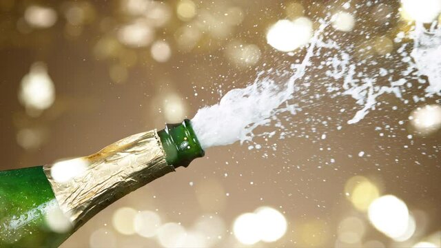 Super slow motion of Champagne explosion with flying cork closure, opening champagne bottle closeup. Filmed on high speed cinematic camera at 1000 frames per second.