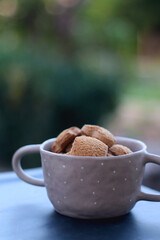 Bowl of cinnamon cookies, served in a garden. Selective focus.