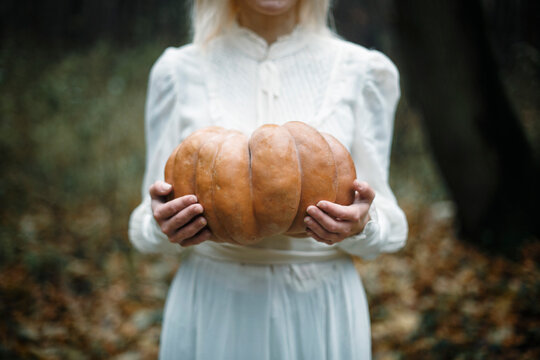 Cropped image of woman holding a pumpkin