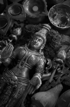 Grayscale photo of Buddha figurine surrounded by Diwali ornament