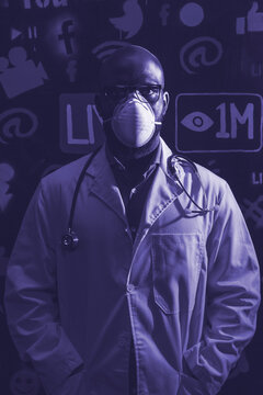 Grayscale photo of doctor with facemask standing