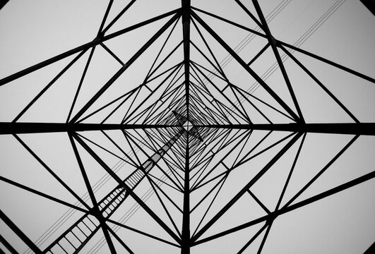 Grayscale photo of ground level and interior view of utility tower
