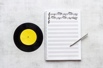 Sheets with music notes and vinyl record. Compose music concept
