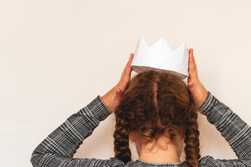 Girl and a  paper crown.
