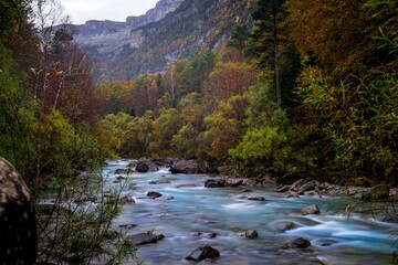 Photograph of the Arazas River as it passes through the Ordesa y Monte Perdido National Park, in the Pyrenees of Aragon, Spain.
 - obrazy, fototapety, plakaty