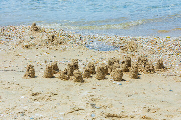 Close up view of beautiful sand composition on beach on blue water background. Greece. 