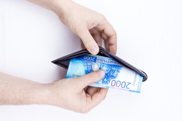 Man taking Russian Rubble out of wallet