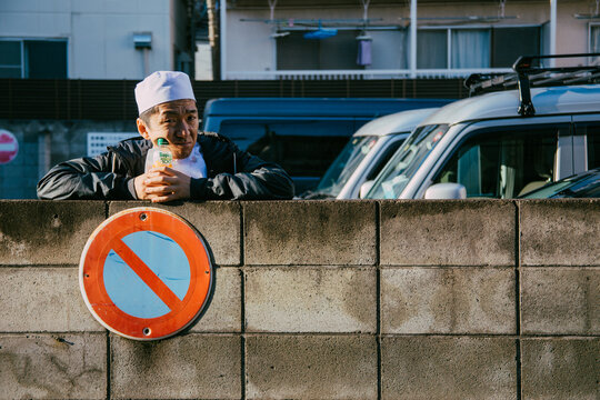 Man wearing Japanese chef hat outdoor in the city