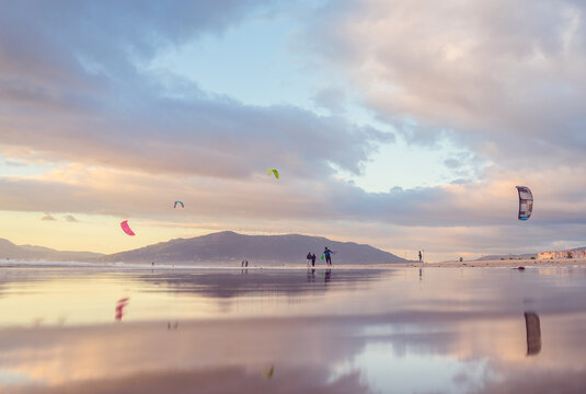 People parachuting above lake