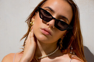 Portrait of woman with sunglasses and golden earrings