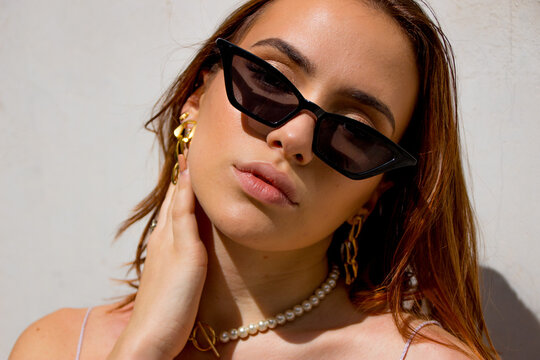 Portrait of woman with sunglasses and golden earrings
