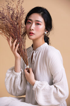 Portrait Of Young Woman Holding Bouquet