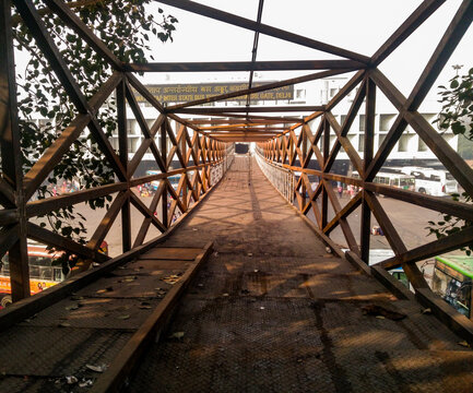 Rusted iron bridge near building