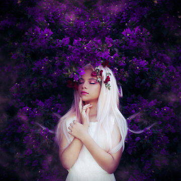 Teenage Girl With Blond Hair Closing Both Eyes Standing Front Of Purple Flowers