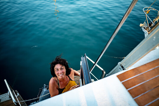 Top view of woman standing on the side of yacht
