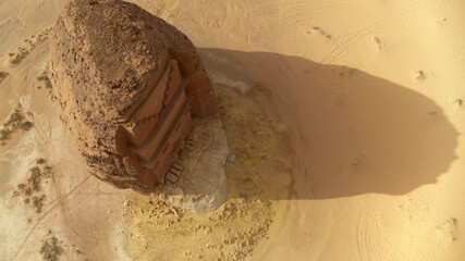 Aerial Beautiful Shot Of Rock Built Structure In Sunlight Over Desert Landscape - AlUla, Saudi Arabia