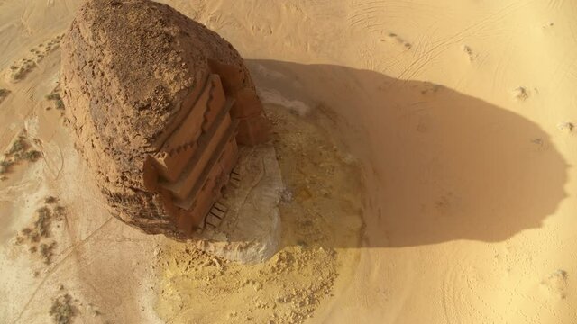 Aerial Beautiful Shot Of Rock Built Structure In Sunlight Over Desert Landscape - AlUla, Saudi Arabia