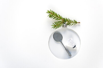 Christmas tree toy made of badminton ball with feather and rocket on white background. Background...