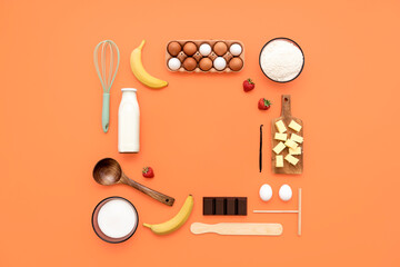 Crepes ingredients and utensils flat lay on an orange table.