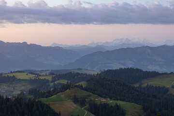 Amazing sunset at a wonderful landscape in Switzerland on a hill called Napf. Wonderful morning view with the alps in the horizon.