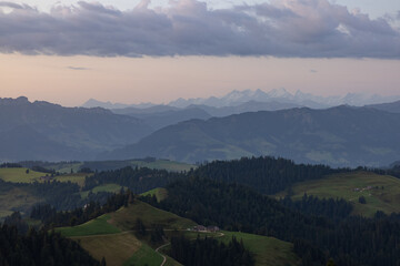 Naklejka premium Amazing sunset at a wonderful landscape in Switzerland on a hill called Napf. Wonderful morning view with the alps in the horizon.