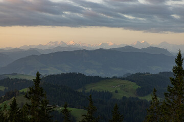 Amazing sunset at a wonderful landscape in Switzerland on a hill called Napf. Wonderful morning view with the alps in the horizon.