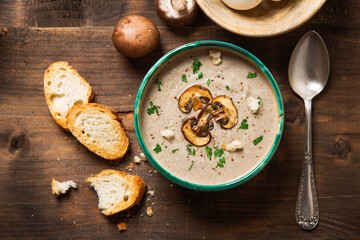 Homemade creamy mushroom soup on a rustic wooden table