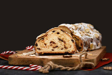 German Stollen cake, a fruit bread with nuts, spices, and dried or candied fruits, coated with...