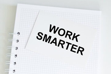 Inspirational and motivation life quote on paper note - Work harder not smarter.