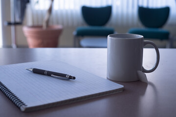 cup of tea with a pencil and note