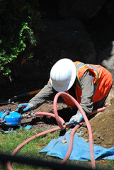 Man repairing underground water pipe