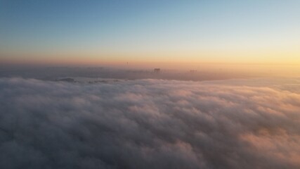 Fototapeta na wymiar City in the fog on the sunrise 