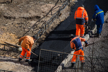 Men working asphalt road