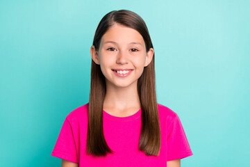 Photo of happy positive small girl good mood smile wear casual pink t-shirt isolated on pastel teal...