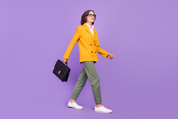 Full length photo of serious senior old woman wear business clothes suitcase isolated on purple color background