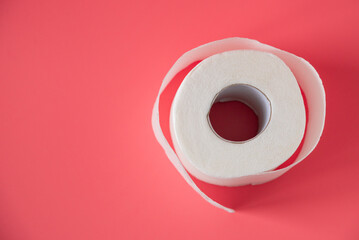 Toilet paper on pink background