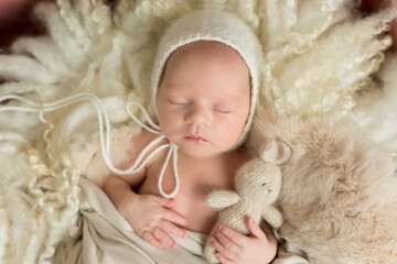 baby posing first photo session. newborn baby. baby in a hat on the background.