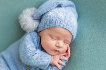 baby posing first photo session. newborn baby. baby in a hat on the background.