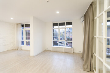 Modern white loft room with big windows and city view
