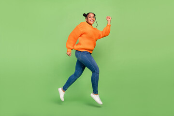Fototapeta na wymiar Full length profile photo of funny millennial brunette lady run wear sweater jeans footwear isolated on green background