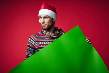 handsome man in a santa hat holding a banner holiday studio posing