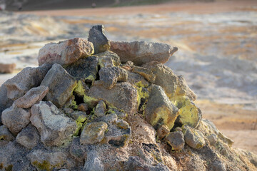 Landscape of sulfur covered rocks at Mt. Námafjall Fumaroles boiling mud pit Diamond Circle Iceland