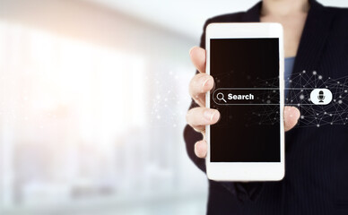Data Search Technology Search Engine Optimization. Hand hold white smartphone with digital hologram search data sign on light blurred background. Minimal blank search bar with voice command