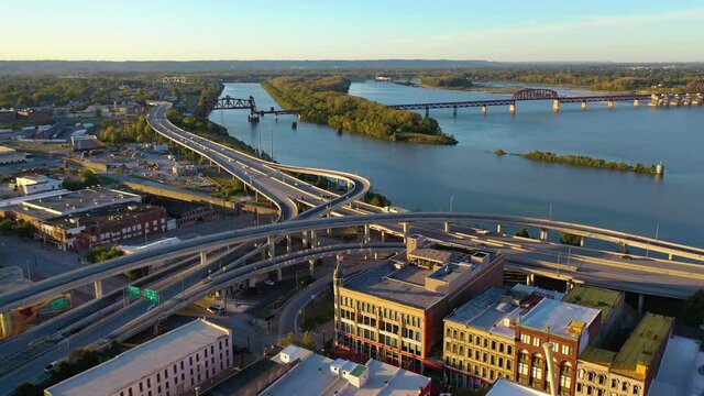 Aerial over freeway interchange in Louisville, Kentucky with Ohio River background suggests infrastructure.