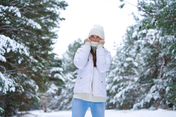 Close up portrait of happy girl in jacket  enjoying winter moments. Outdoors photo of a long-haired...