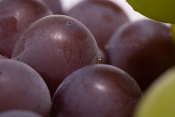 A macro shot of a bunch of Niagara grapes.