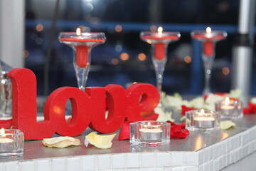 Romantic candlelight dinner. The scenery is in red. Close-up.