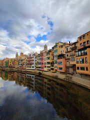 Colorful historical houses,facades, reflected in water of the river Onyar, in Girona, Catalonia, Spain.
